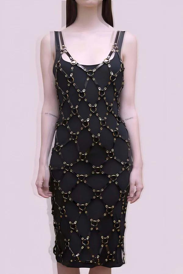 Black faux leather geometric panel overlay harness midi dress with gold O-ring hardware linking panels from neckline to hem