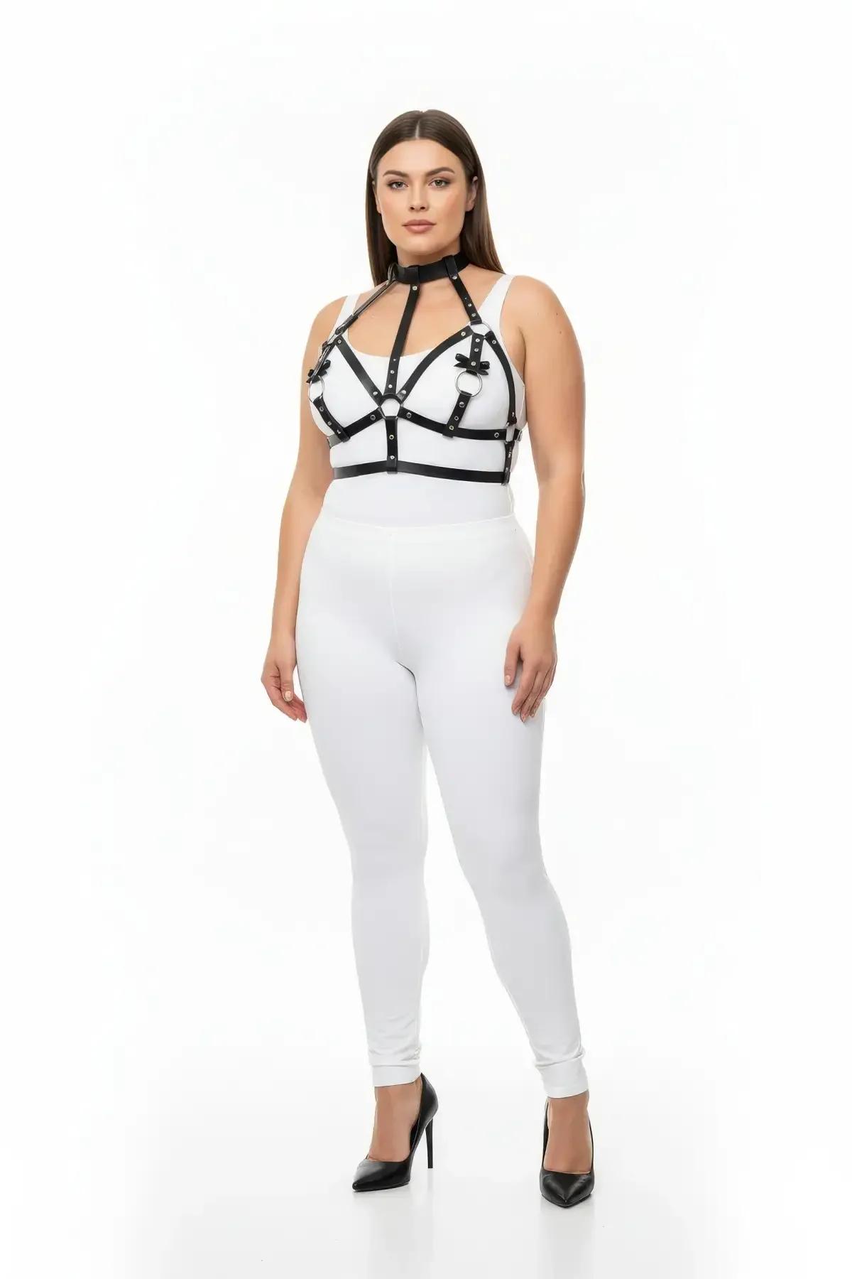 black strappy harness cage detail showing silver O-ring and bow accents at strap junctions