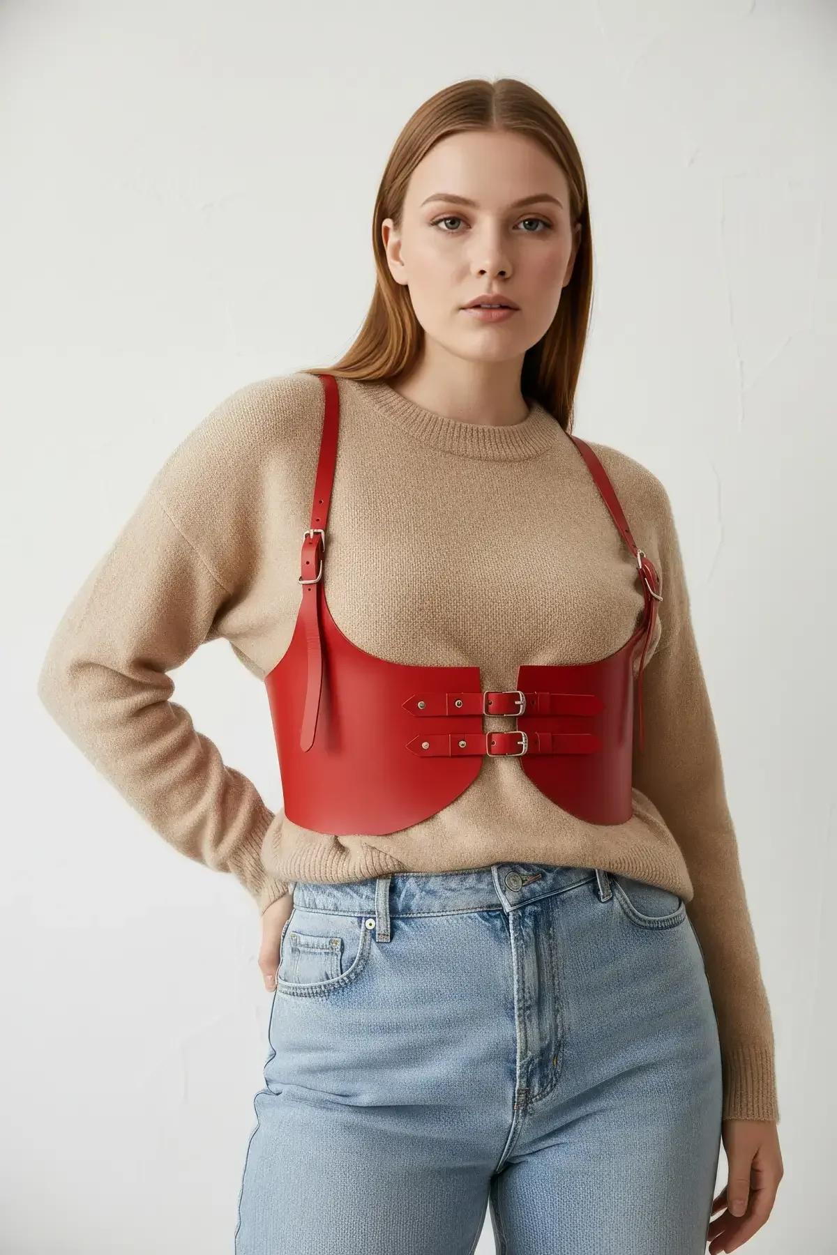 red vegan leather underbust corset belt harness on plus-size model with high-waist jeans