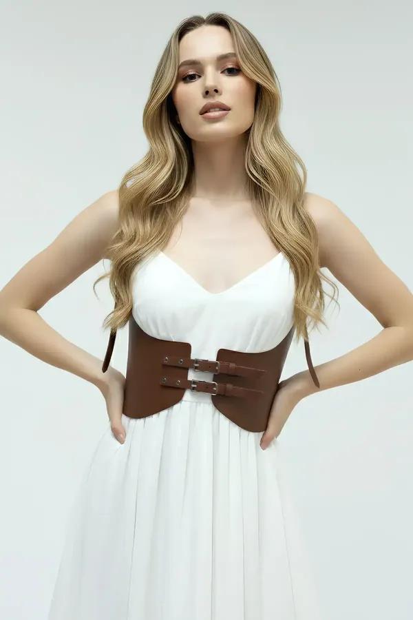 brown faux leather underbust harness with double gold buckle straps worn over white bodysuit