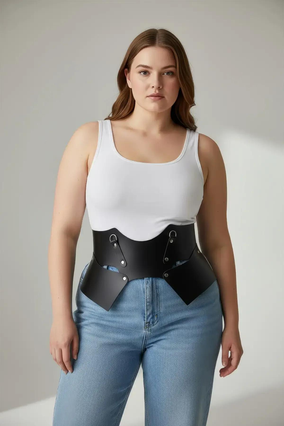 Close-up of silver D-ring hardware detail on black sculptural faux leather corset belt