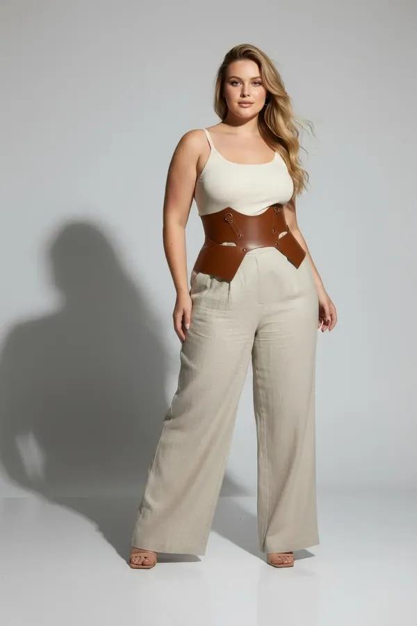 cognac faux leather underbust waist cinch harness with detachable hip panels and gold O-ring hardware worn over white tank to
