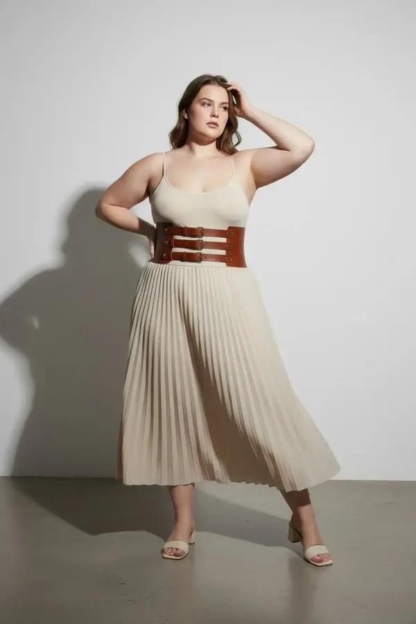 brown faux leather wide waist cinch harness belt with three silver-tone adjustable buckle straps worn over white tank top