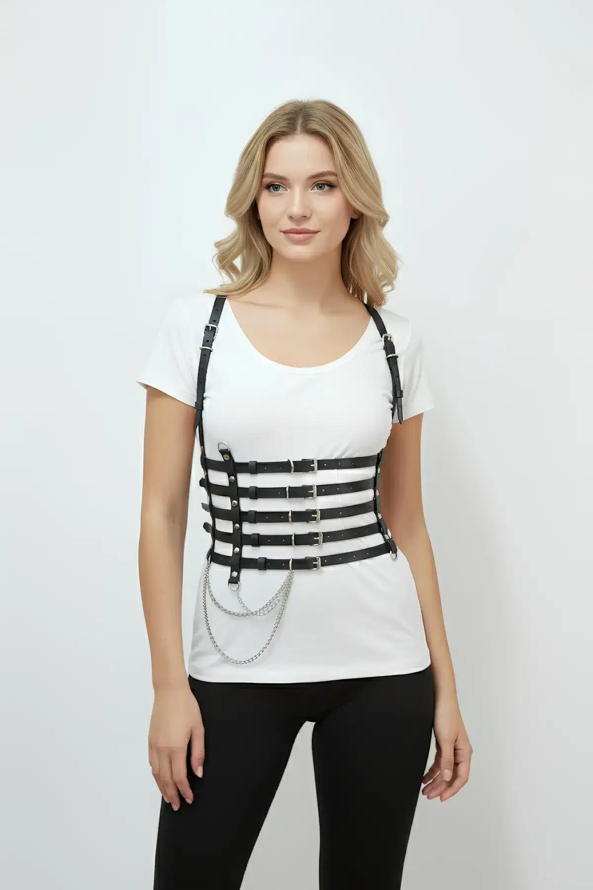 black faux leather four-band waist harness worn over black high-waist trousers showing full length
