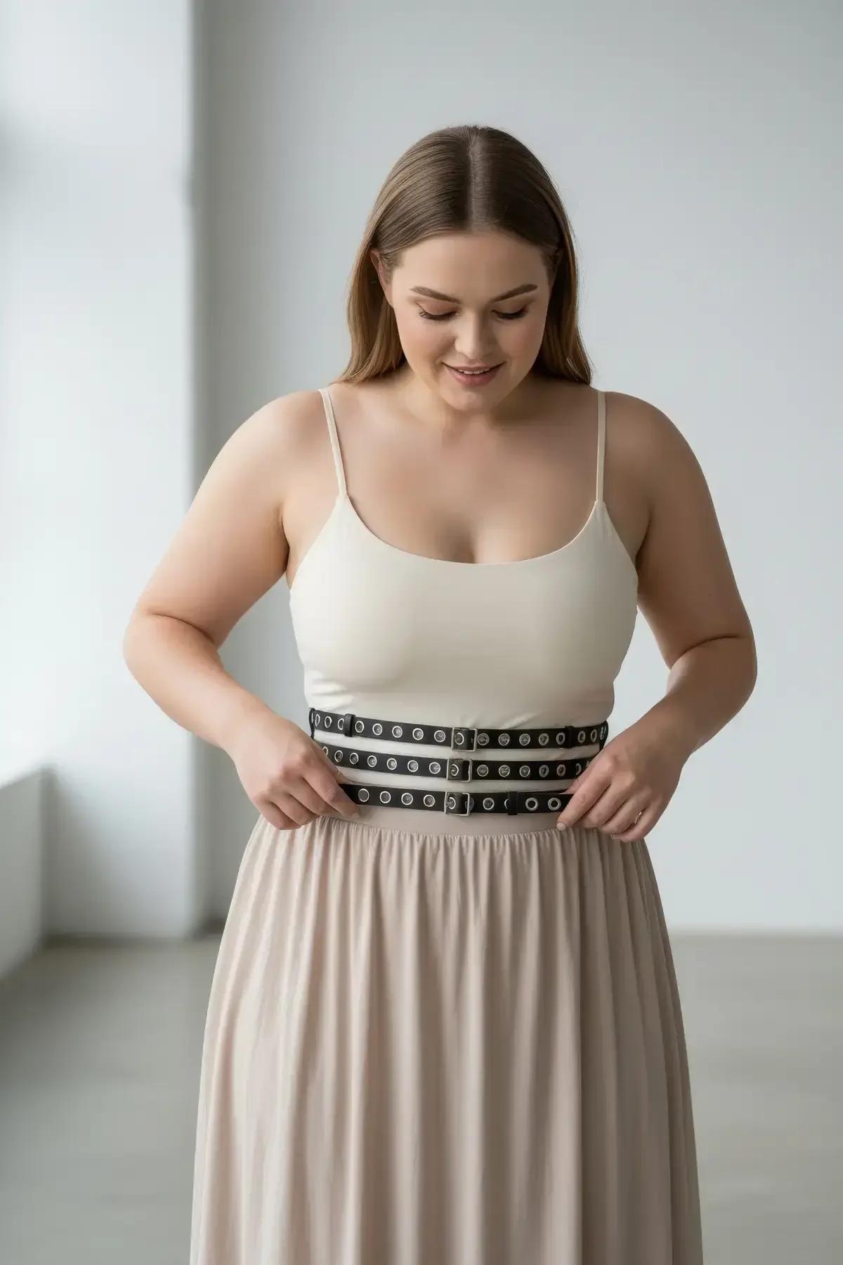 black triple-strap waist cinch harness belt laid flat showing three adjustable straps and silver hardware