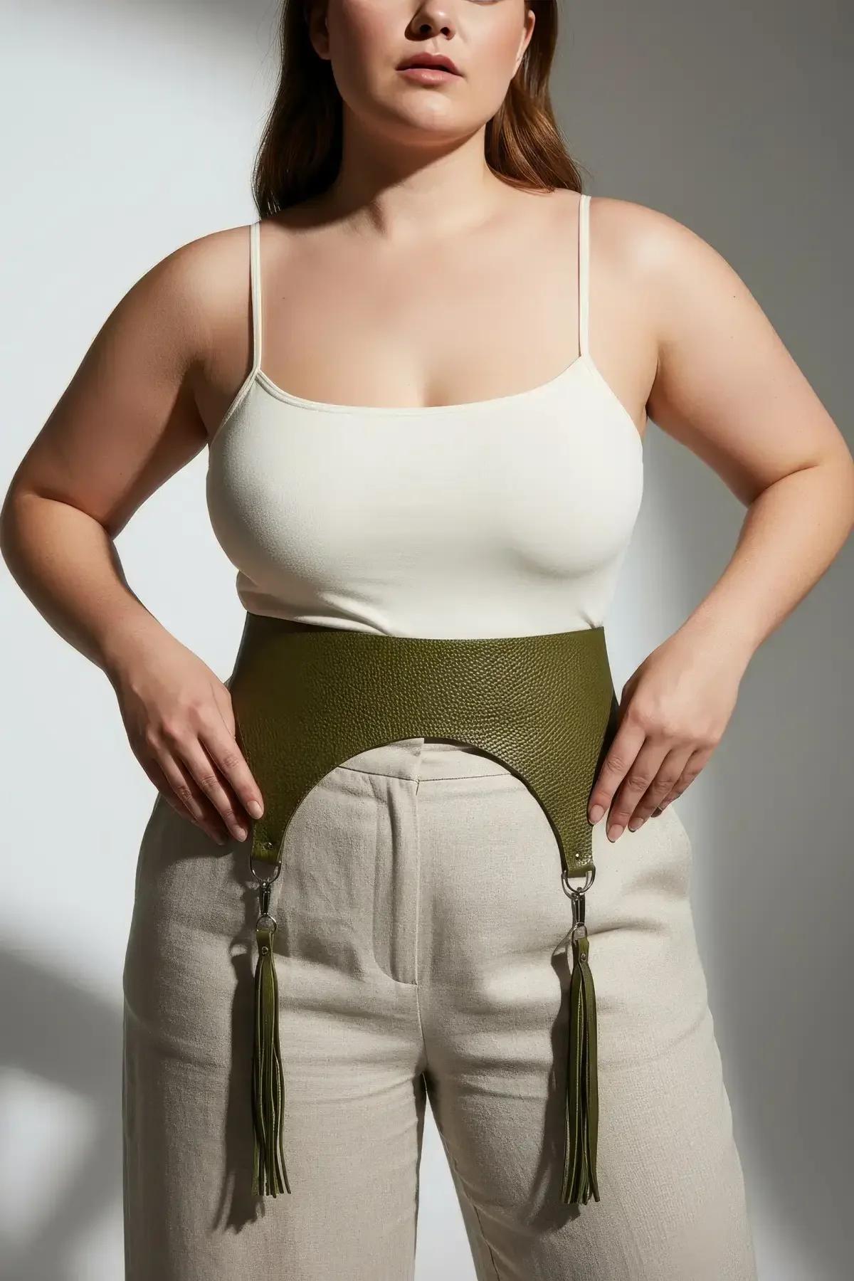 Ribbed olive high-waist harness with matching knit fringe garters flat lay on white surface