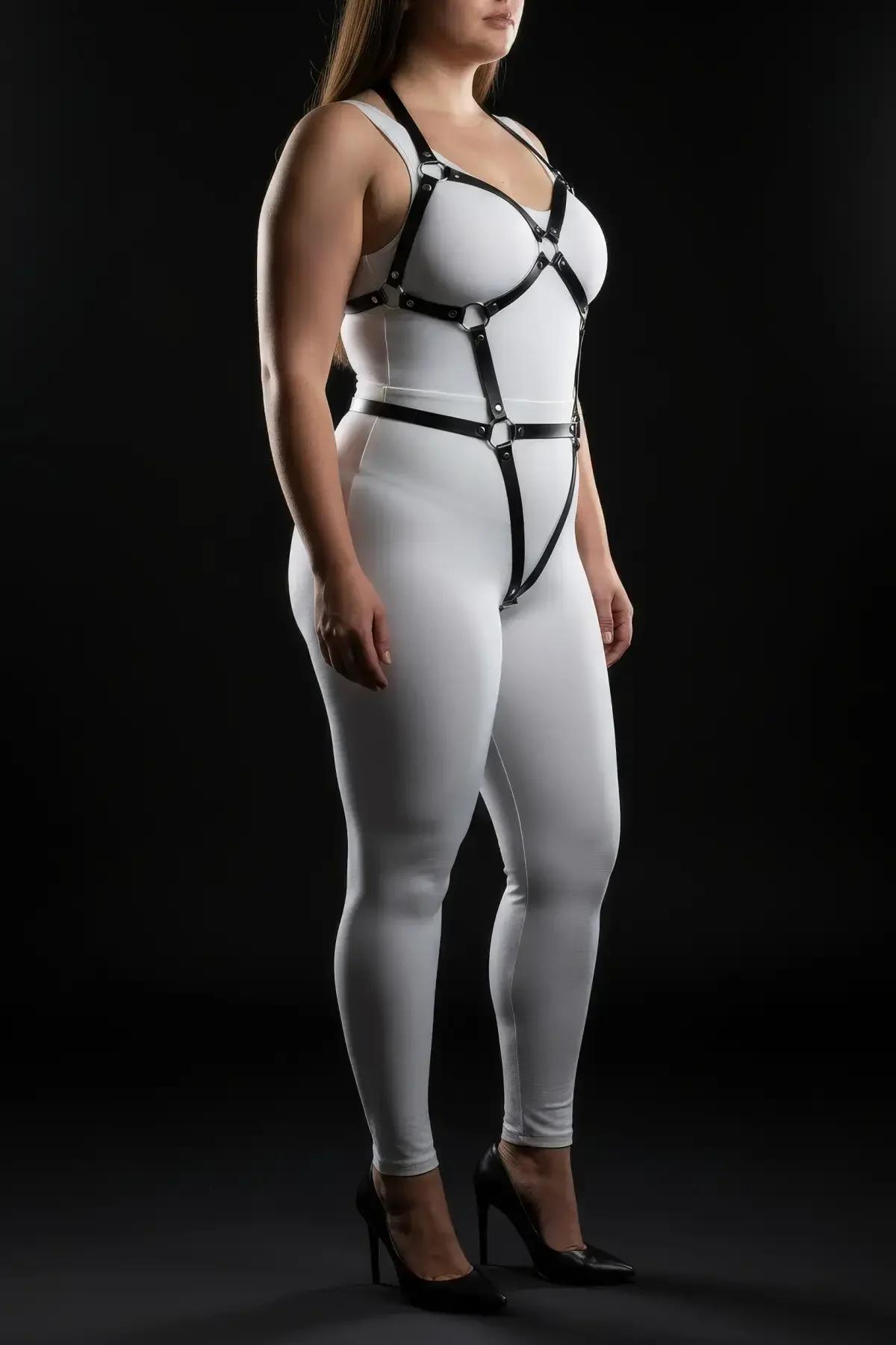 Black full body harness chest frame detail showing sweetheart-shaped strap arrangement and six O-rings