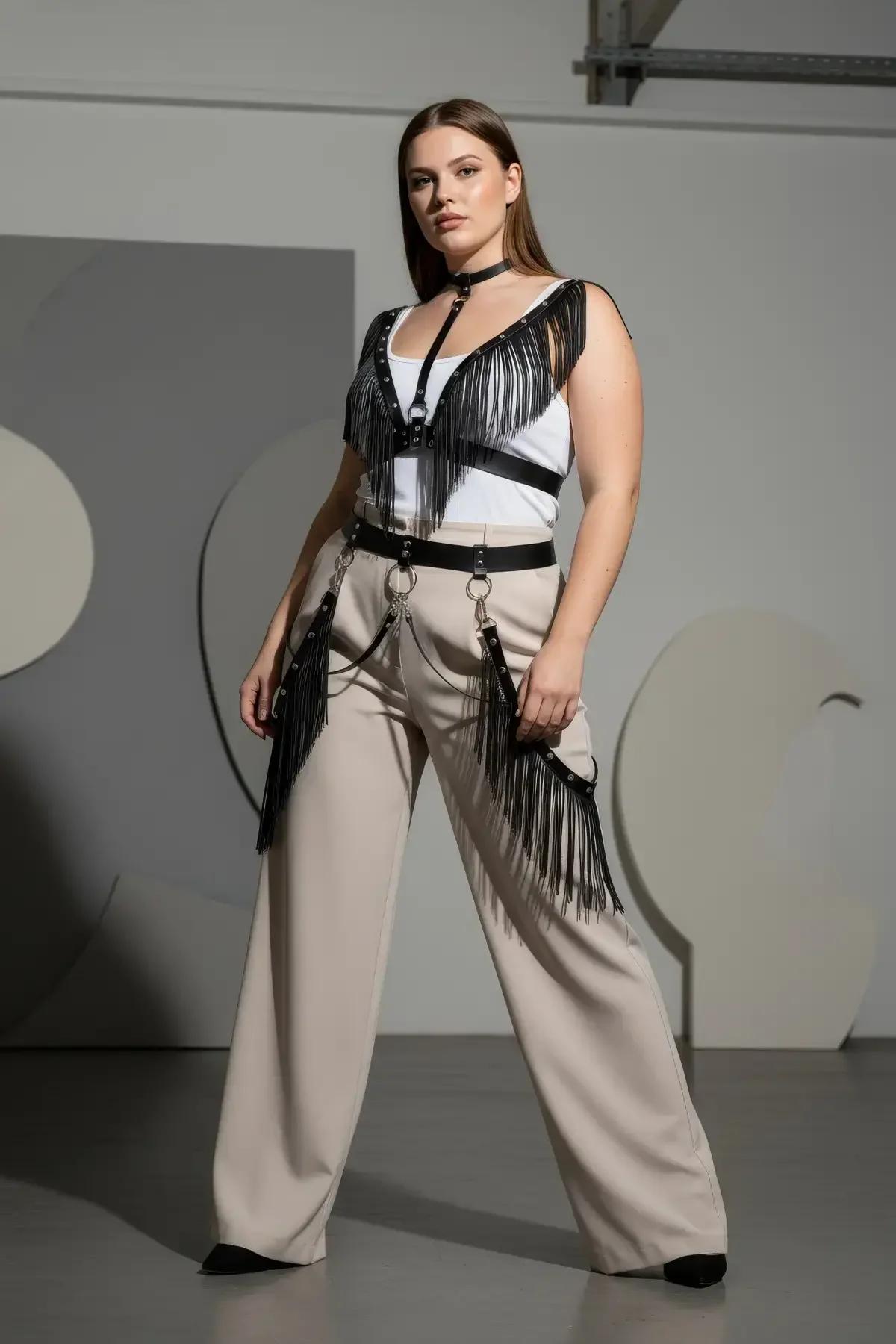 back view of black vegan leather harness showing adjustable buckle strap closures and fringe drape