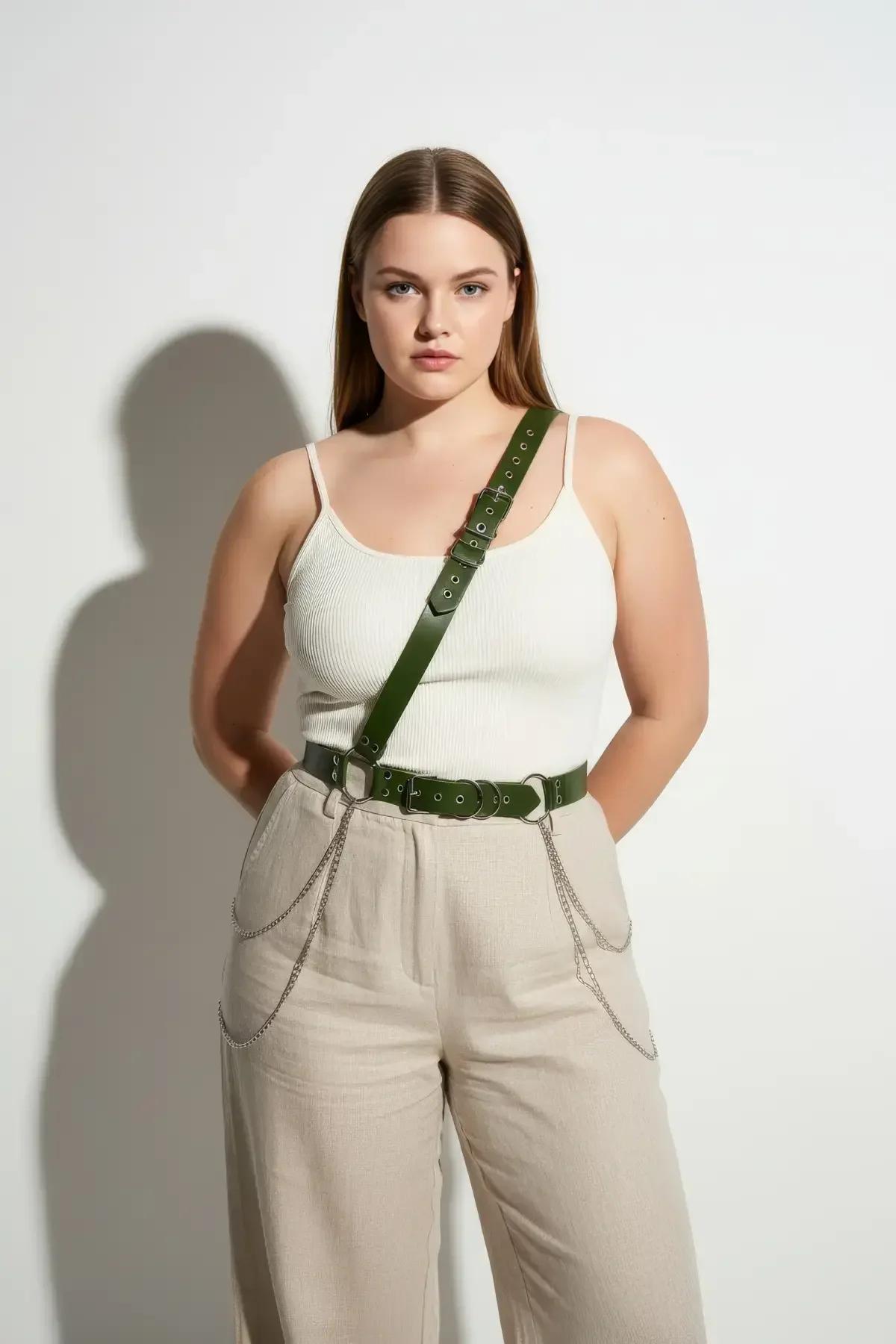 Dark green leather-look harness flat lay showing full strap configuration, buckles, and silver chain attachments