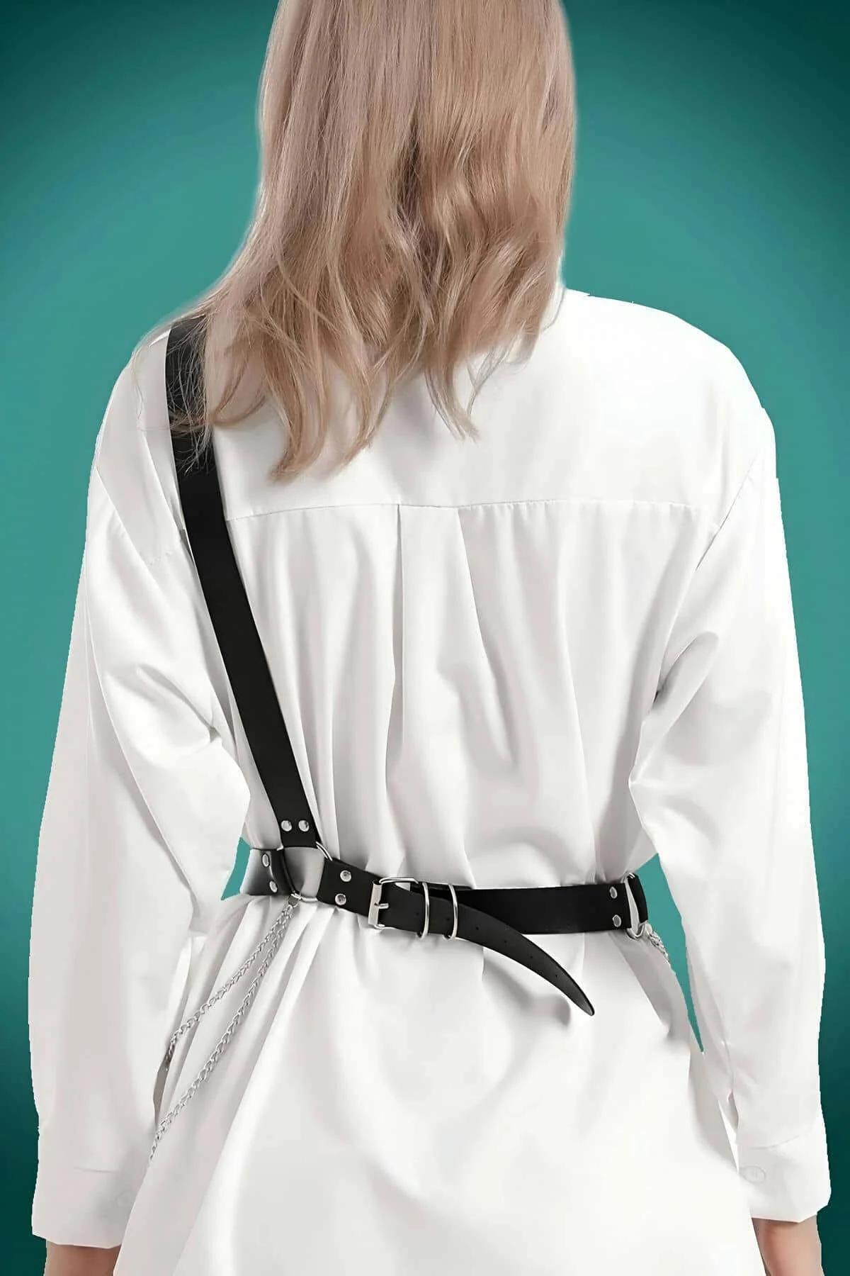 Close-up of three silver O-ring buckles on black PU faux leather waist harness belt