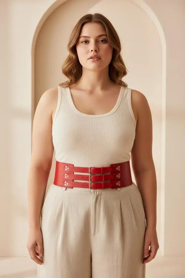 red faux leather wide waist cinch harness belt with three silver double-bar buckle straps on plus-size model