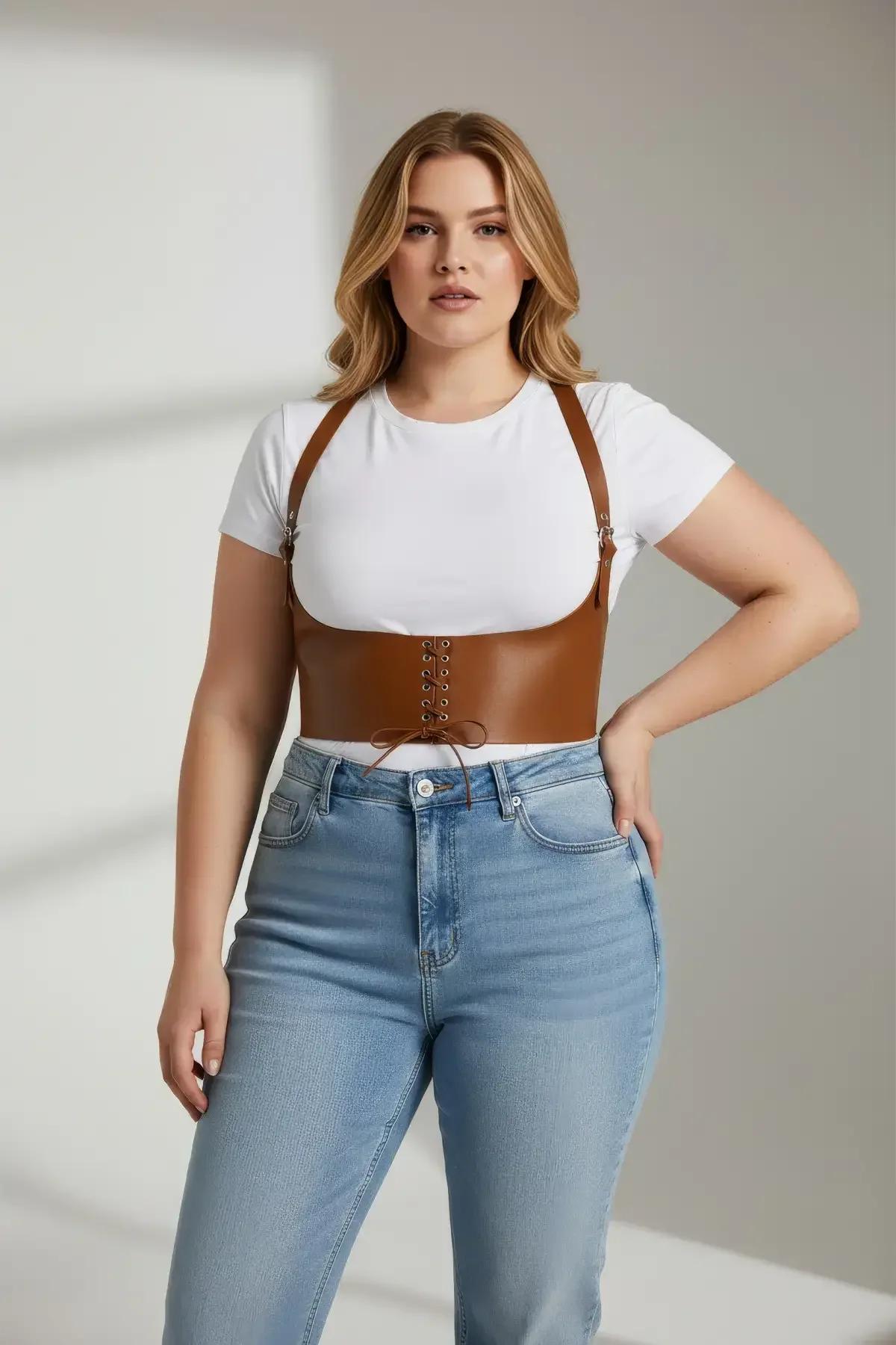 tan vegan leather corset harness lace-up front detail with gold-tone metal eyelets close-up