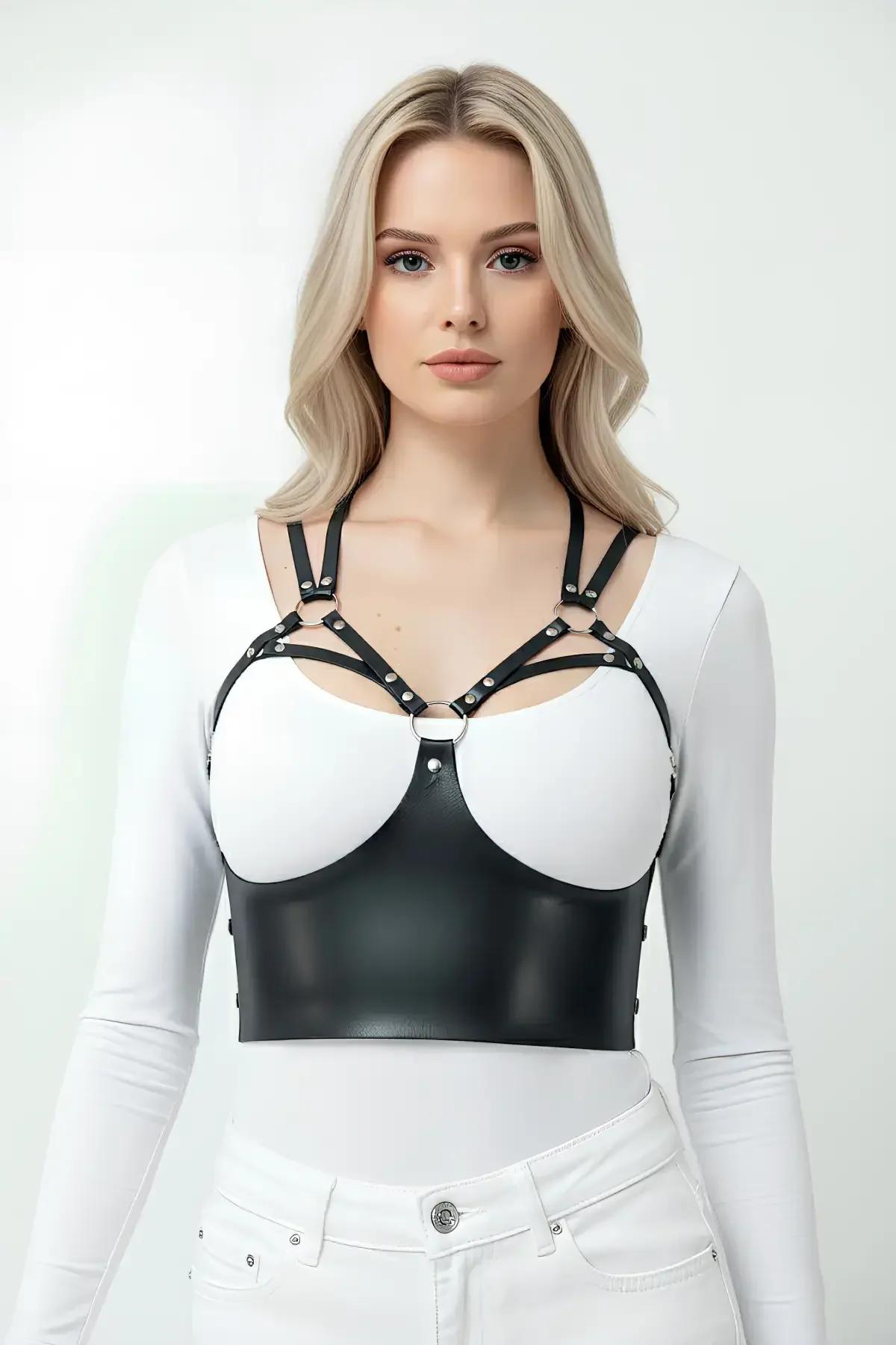 black studded cup bustier harness layered over white fitted shirt with white shorts
