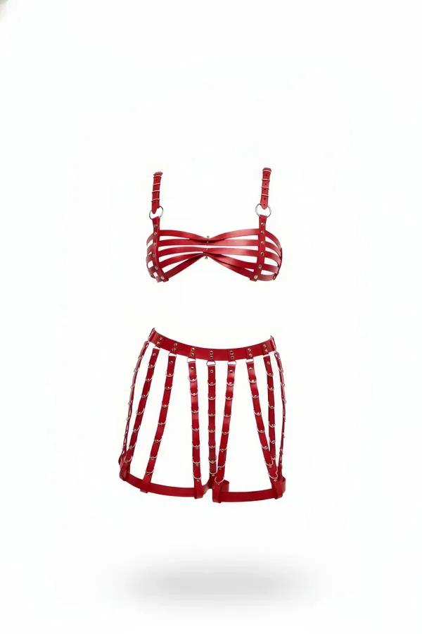 Red caged faux leather bra and shorts lingerie set with silver O-rings on white background