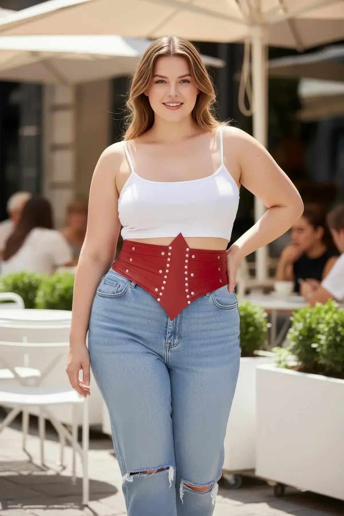 Close-up of red PU faux leather corset belt showing two rows of silver dome studs on structured front panel