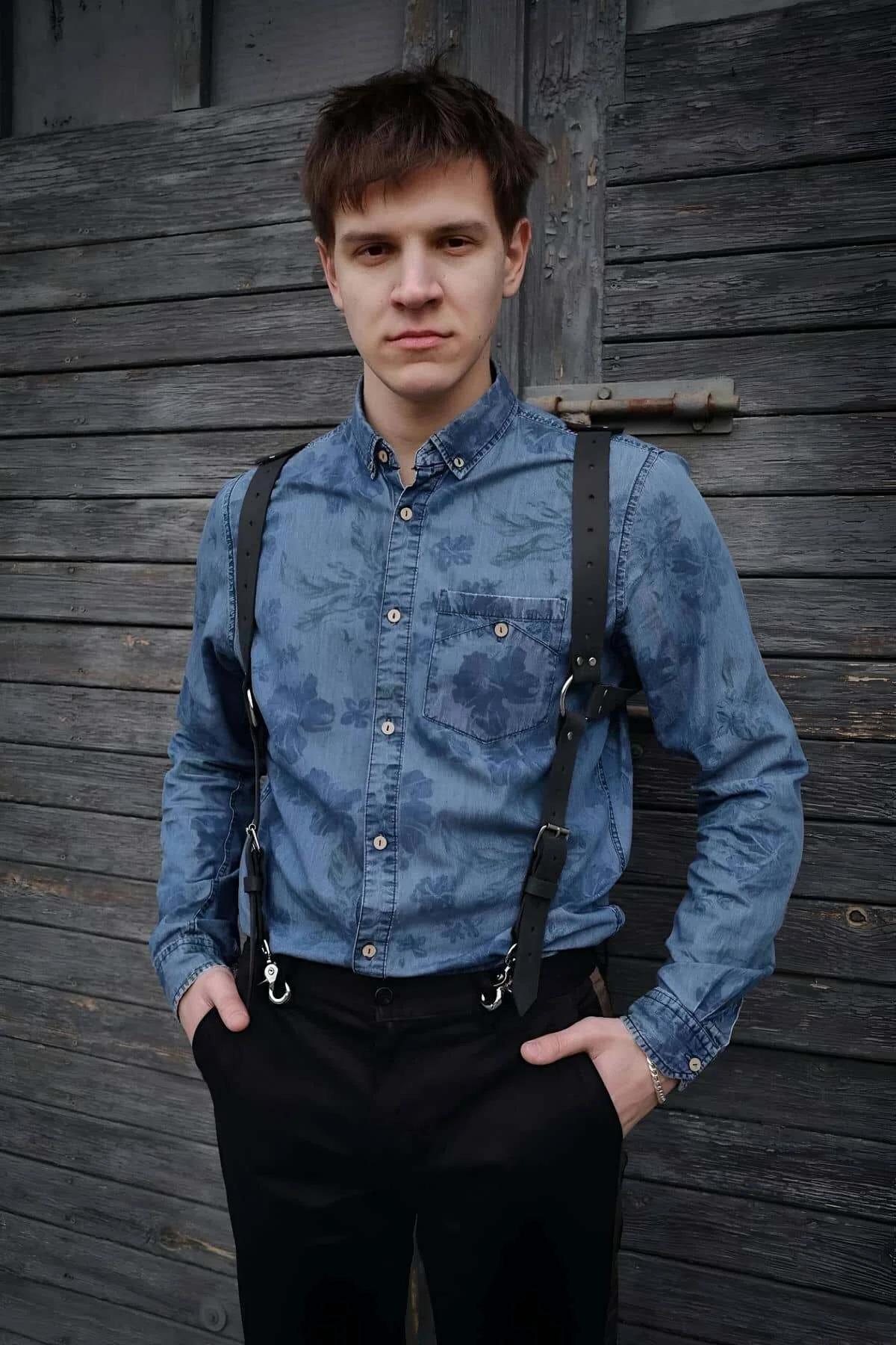 Men's back harness with adjustable silver buckles at each shoulder worn over denim shirt