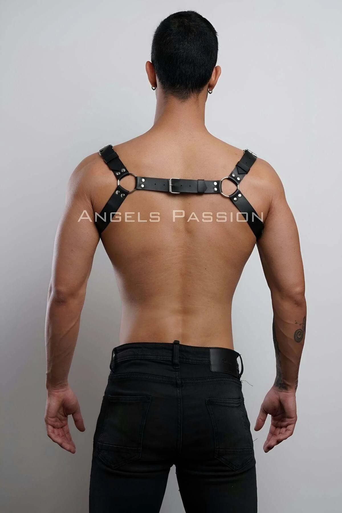 mens black faux leather harness with three O-rings styled over bare chest with black jeans
