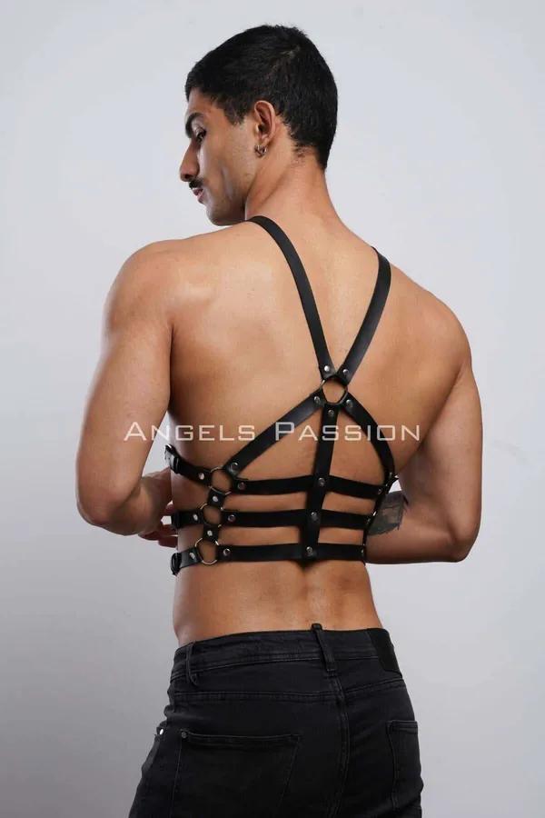 Black faux leather cage body harness back view with gold O-ring connectors and X-cross shoulder straps on male model