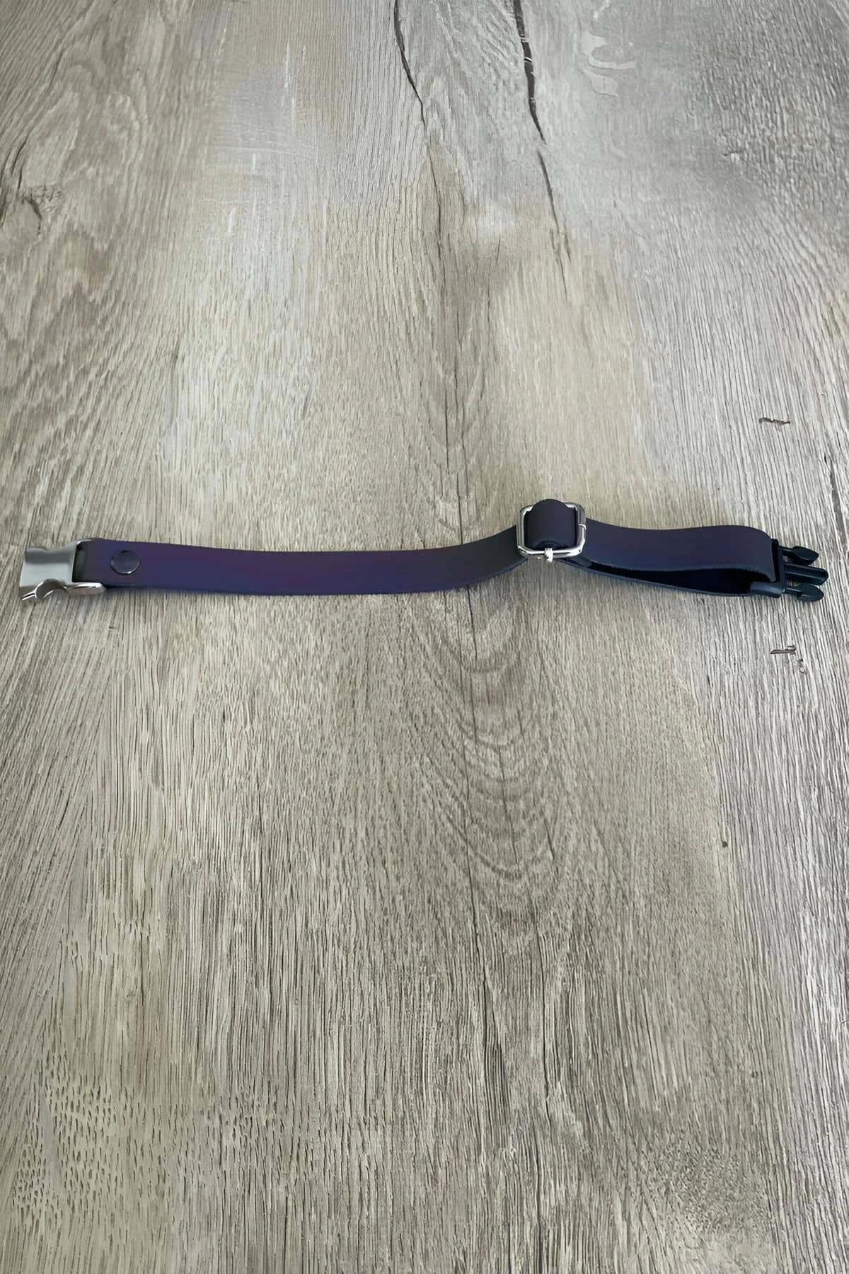 Top view of blue reflective cat collar showing full strap length and metal hardware
