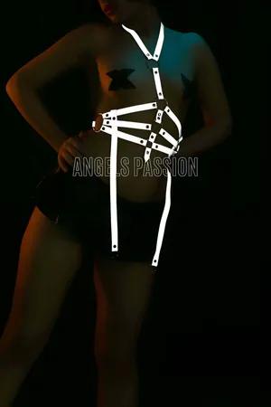 White reflective O-ring body harness with adjustable straps worn by a model