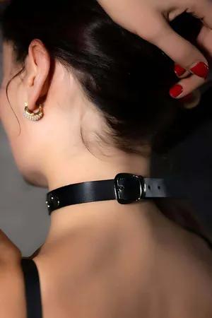 Black faux leather choker with silver buckle and strap details