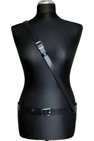 Minimalist black faux leather body harness with adjustable waist and shoulder straps and silver buckles.