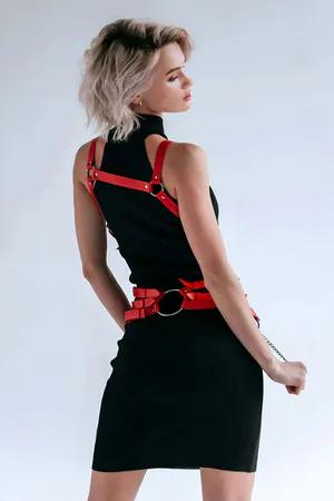 Red faux leather body harness with silver chain detail and adjustable straps