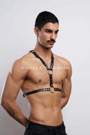 Black faux leather adjustable body harness with O-ring and rivets, worn by a male model.