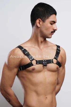 Black faux leather chest harness with silver O-ring details and adjustable straps