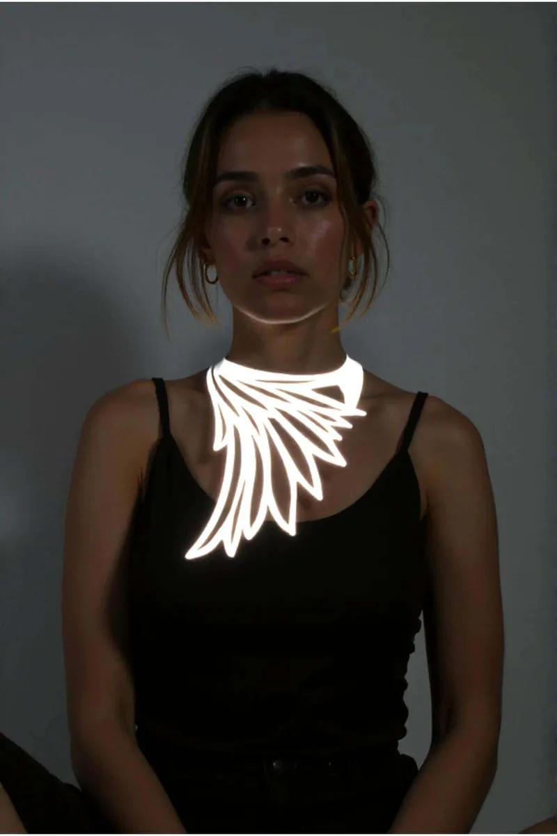 White reflective wing choker necklace on a model