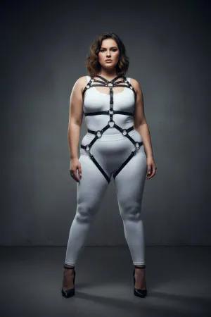 Black faux leather full body harness with O-ring details and adjustable straps on a plus-size model.