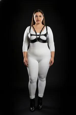 Black faux leather strappy harness bra with central O-ring detail worn by a plus-size model