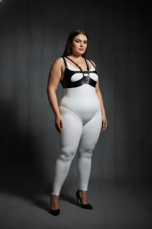 Black faux leather strappy harness bra with central O-ring detail worn by a plus-size model