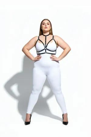 Black faux leather strappy body harness with central O-ring detail, worn by a plus-size model.