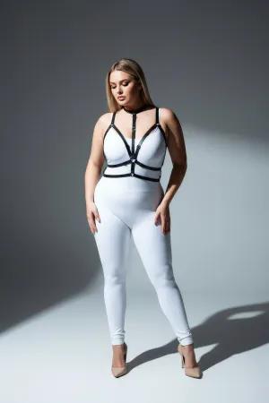 Black faux leather strappy body harness with central O-ring detail, worn by a plus-size model.