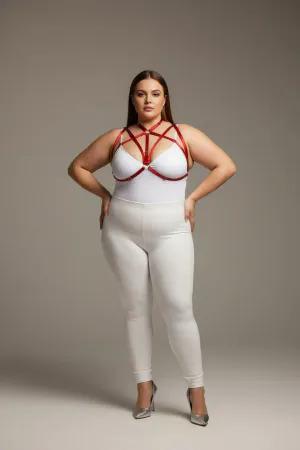 Red faux leather strappy chest harness with O-ring detail worn by a plus-size model