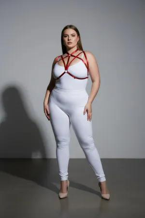 Red faux leather strappy chest harness with O-ring detail worn by a plus-size model