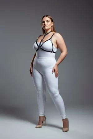 Black faux leather strappy body harness worn by a plus-size model, showing adjustable straps and O-ring detail.