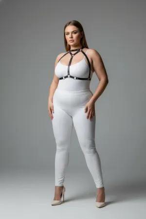 Black faux leather strappy body harness with silver O-rings and adjustable straps worn by a plus-size model.