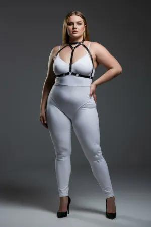 Black faux leather strappy body harness with silver O-rings and adjustable straps worn by a plus-size model.