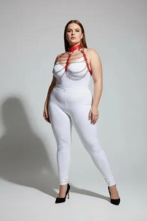 Red faux leather body harness with silver chains and O-ring detail, worn by a plus-size model.
