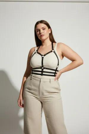 Black Vegan Leather Caged Chest Harness over beige top, featuring silver-toned stud details