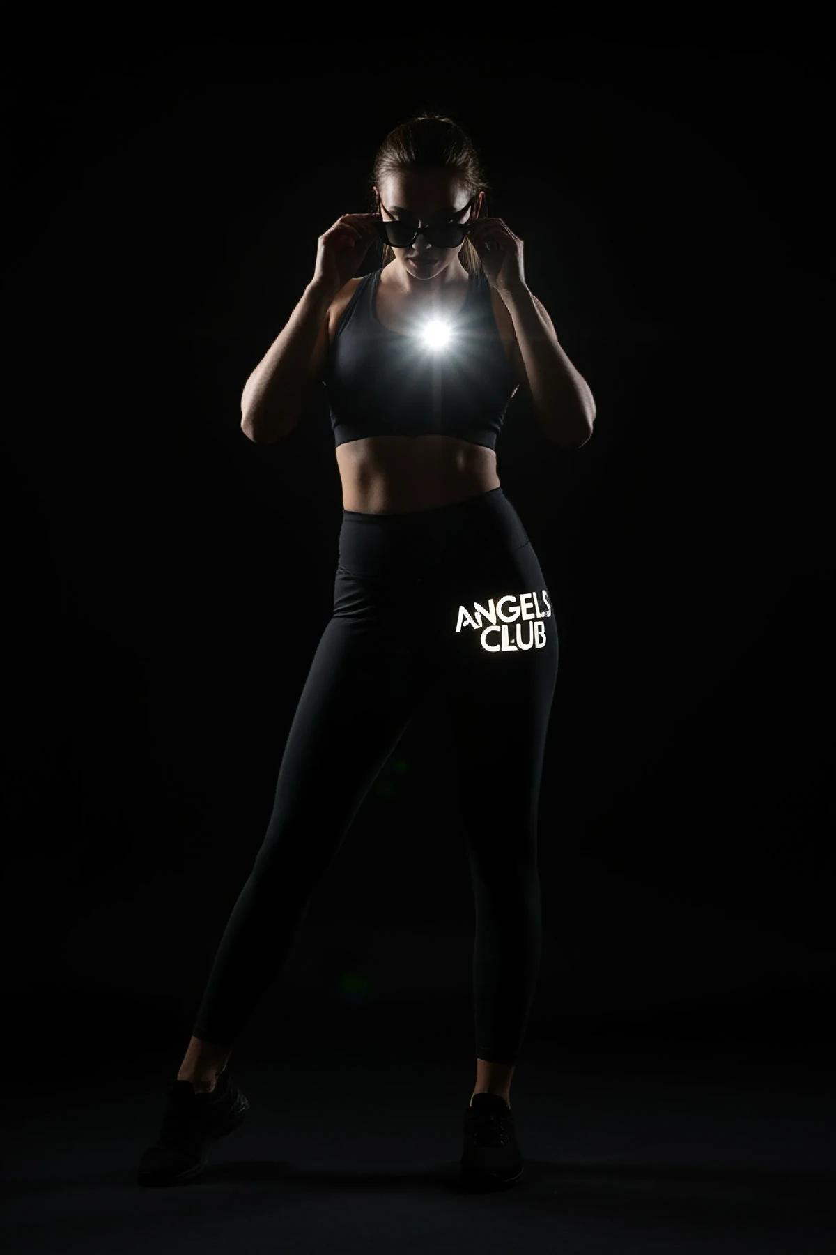 black high waist workout leggings with green reflective side stripe and bold white logo print on thigh