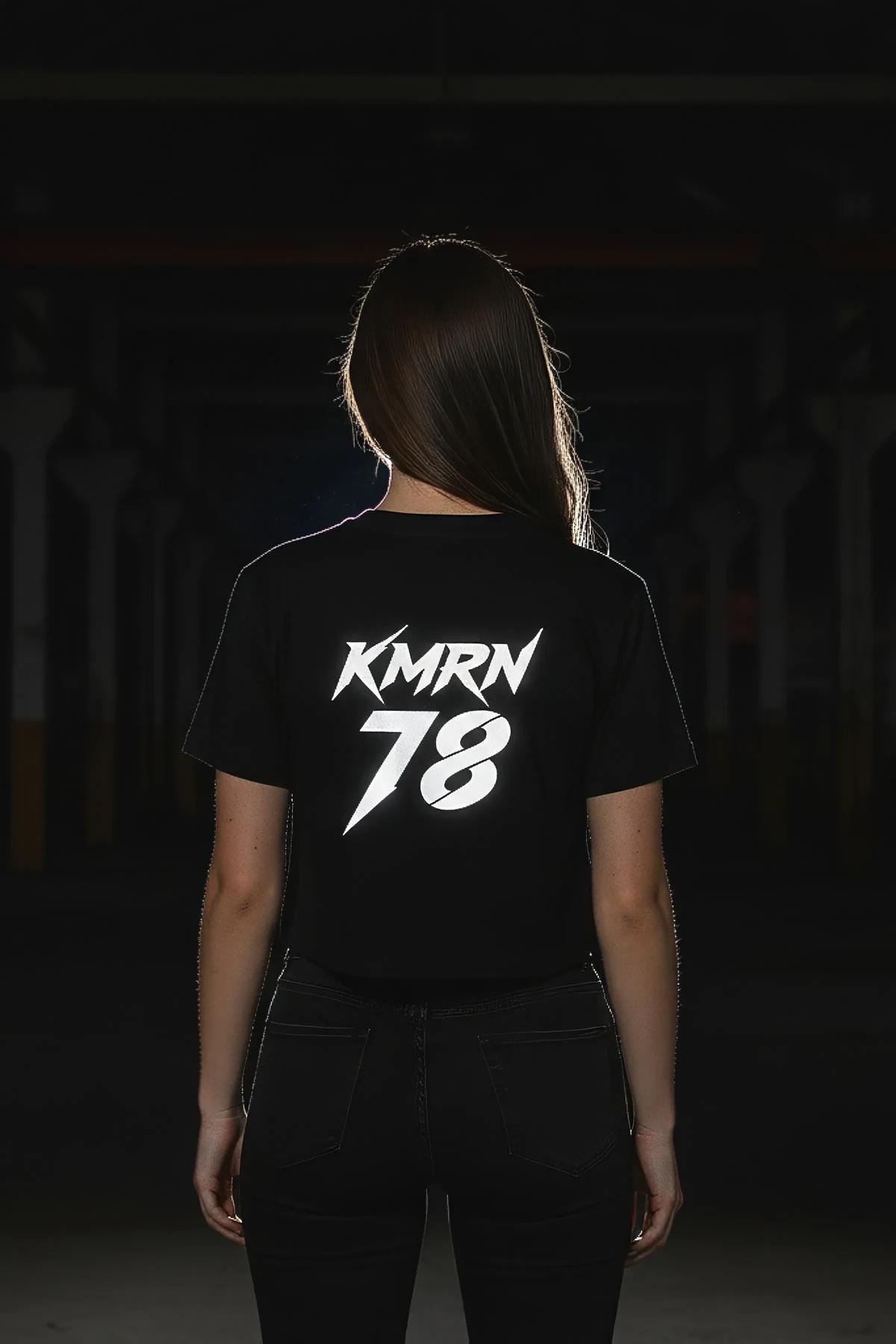 black reflective custom graphic t-shirt back view with bold gothic name and number print glowing white in low light