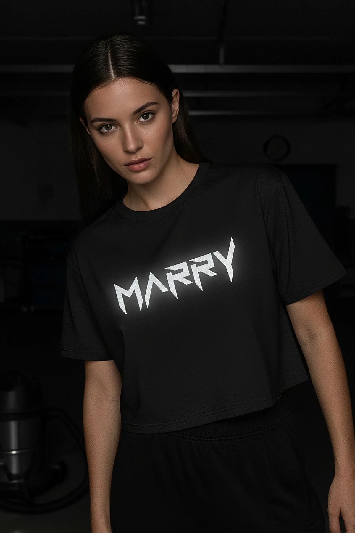 black oversized crop top with bold reflective white MARRY text graphic in jagged font across chest