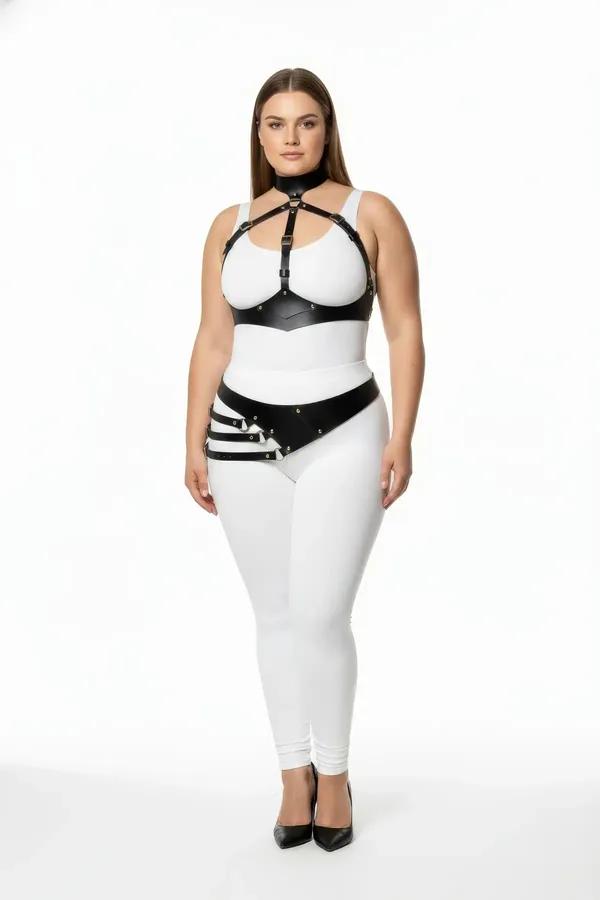 black faux leather full body harness with chest cage collar and diagonal hip belt worn over white bodysuit plus size model