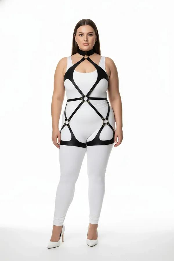 black vegan leather full body harness with neck collar, gold O-ring chest detail, and thigh straps worn over white bodysuit