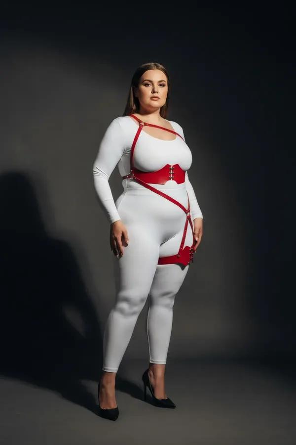 red faux leather strappy body harness with underbust band, diagonal O-ring hip strap, and scallop-edged thigh cuff, silver ha