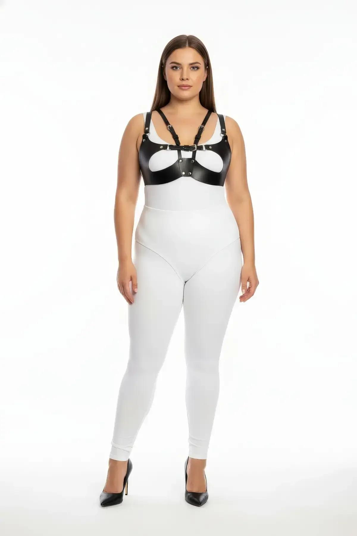 black faux leather harness bra with silver O-ring buckle and oval cut-out chest panel on plus-size model