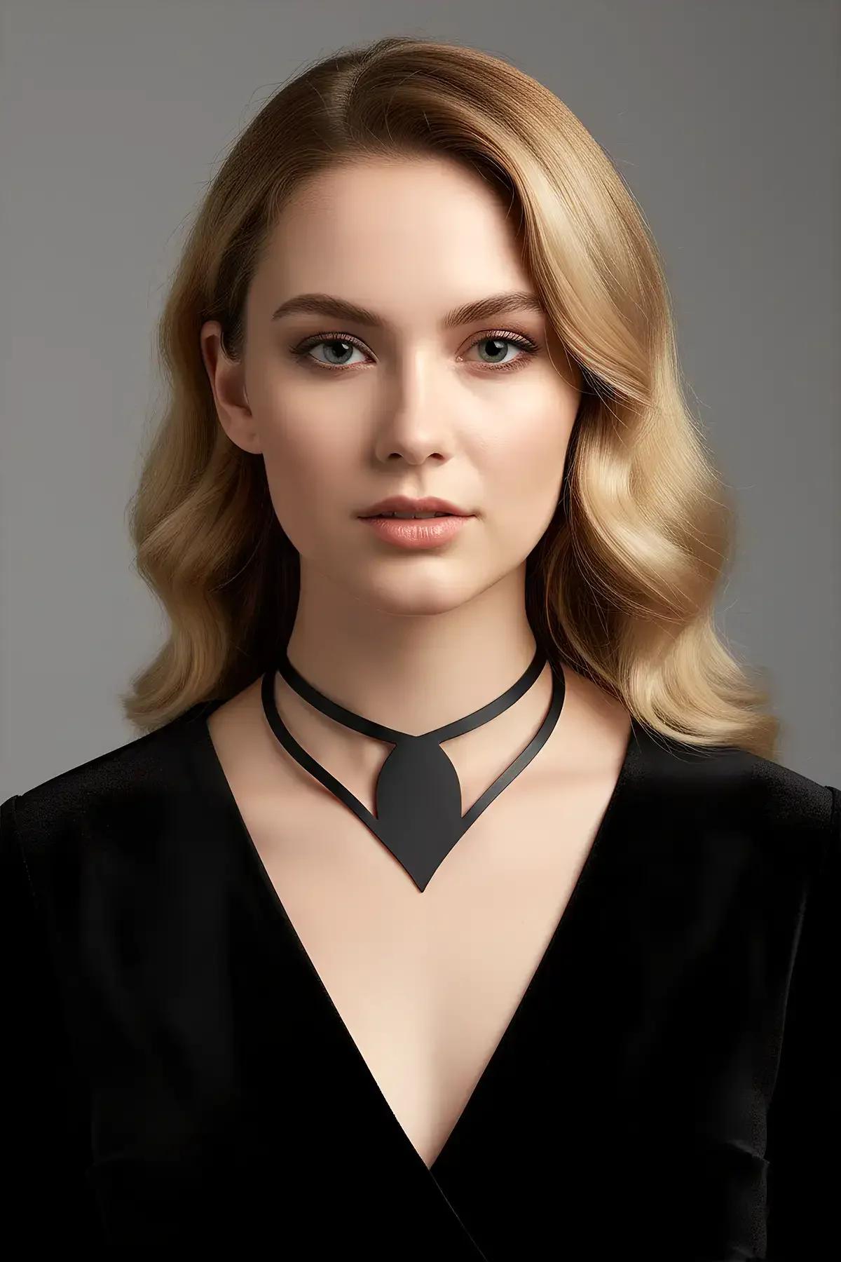 Black matte faux leather choker with geometric V-shape accent panel worn at the throat against a V-neck top